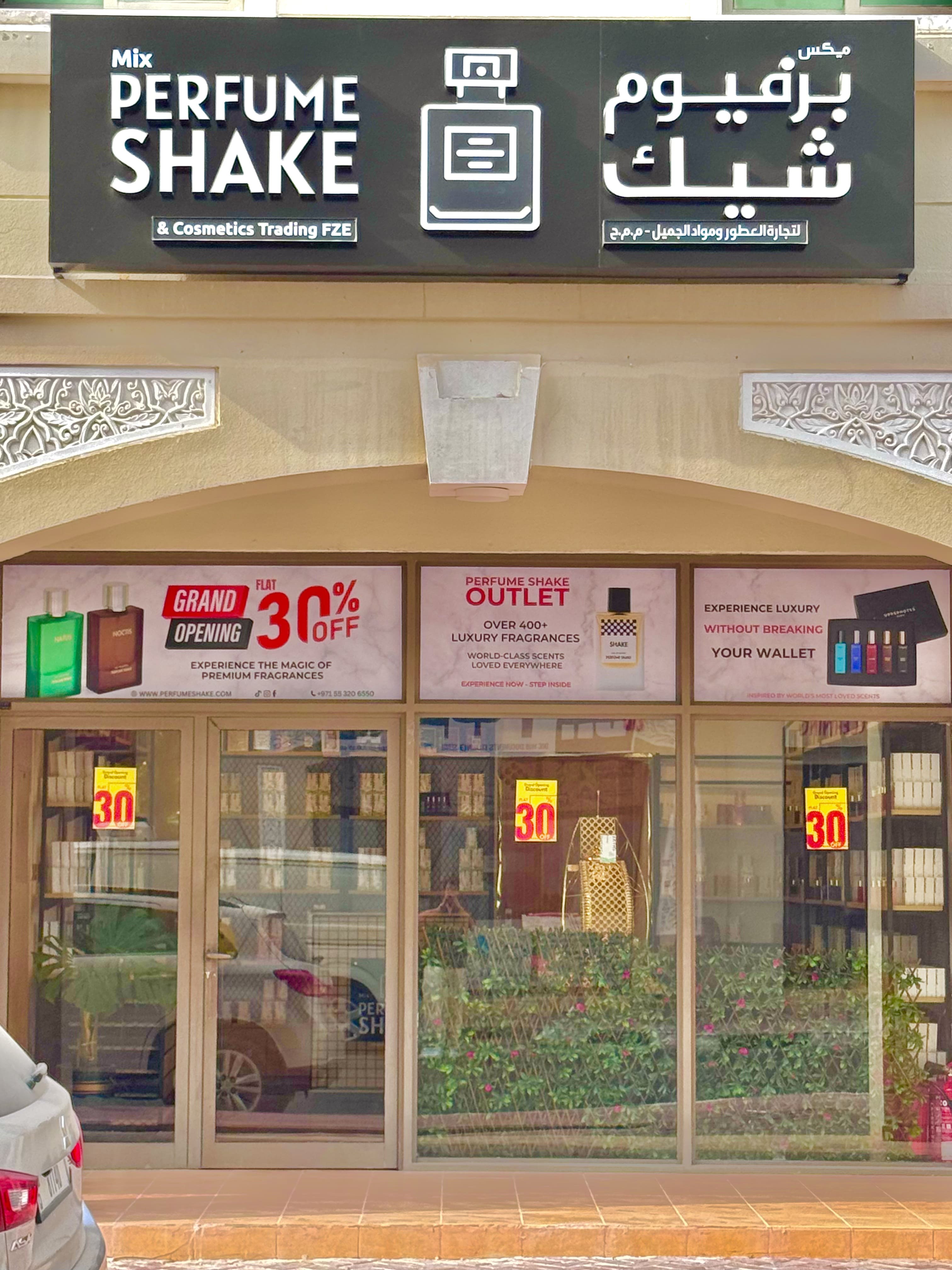 Perfume shake store front with promotional signs and branding.