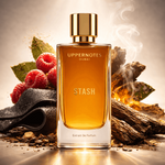 Perfume bottle labeled 'STASH' with natural elements like berries and wood on a textured surface.
