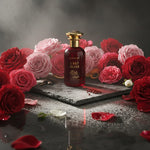 Perfume bottle labeled 'Last Bliss' surrounded by red and pink roses notes on a dark surface unisex perfume in UAE