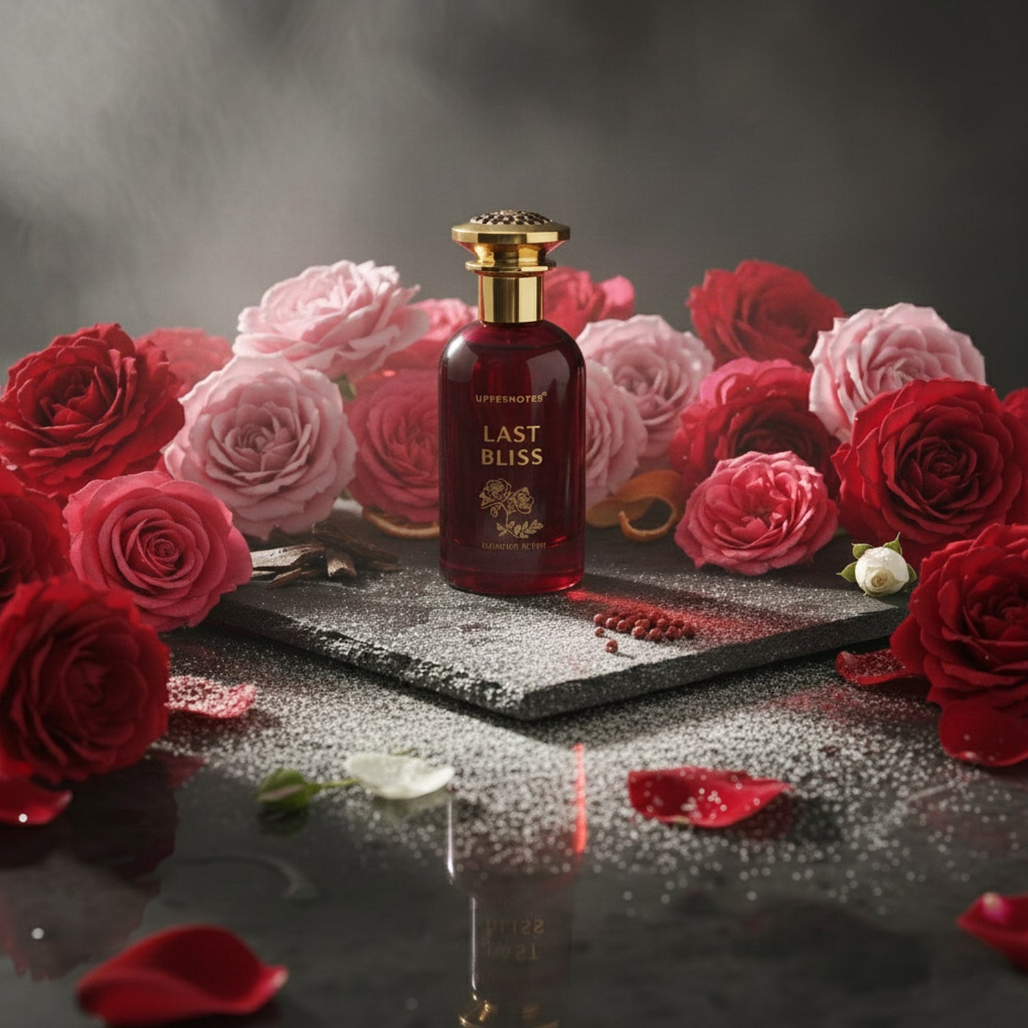 Perfume bottle labeled 'Last Bliss' surrounded by red and pink roses notes on a dark surface unisex perfume in UAE